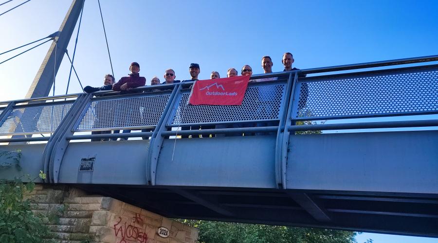 ODL members with red flag behind a sculpture of a knitted ball