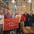Guys with flag at cafe