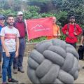 ODL members with red flag behind a sculpture of a knitted ball